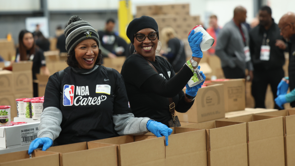 NBA All-Stars package food at Church's storehouse in Salt Lake
