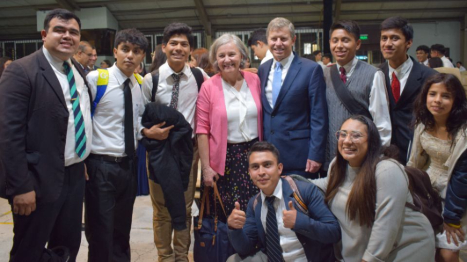 Elder-S.-Mark-Palmer,-a-member-of-the-Presidency-of-the-Seventy,-takes-a-photo-with-young-men-following-a-devotional-in-Guatemala-City,-Guatemala,-on-April-16,-2023.